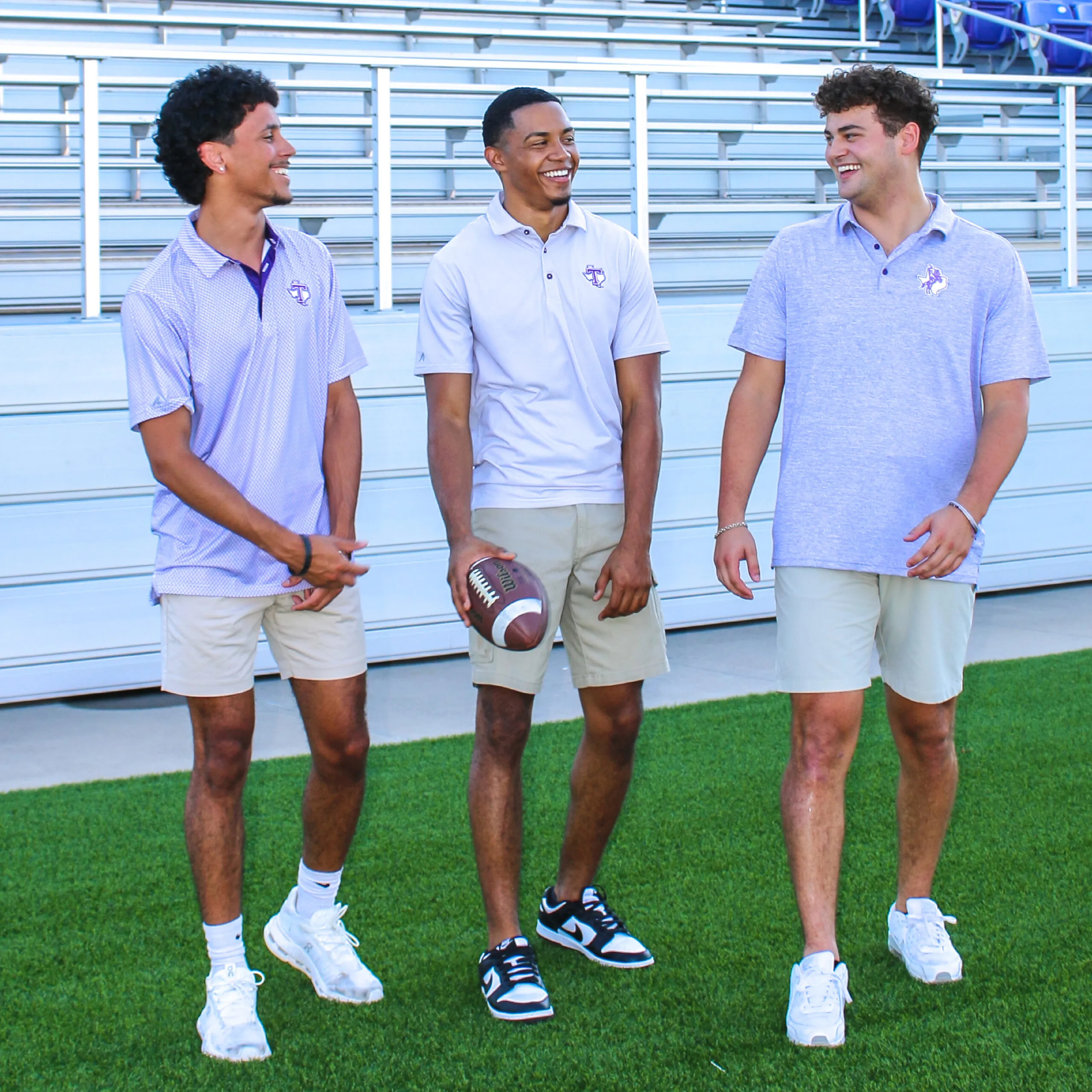 Group of men laughing wearing Tarleton State apparel