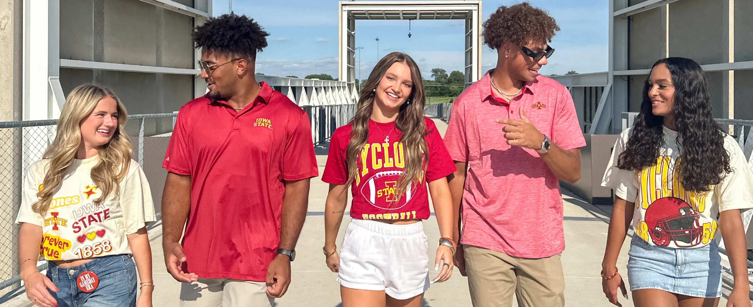 Group of people walking, wearing Iowa State apparel